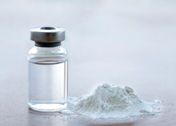 Vial of vaccine with drug powder on white background. GHB