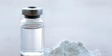 Vial of vaccine with drug powder on white background. GHB